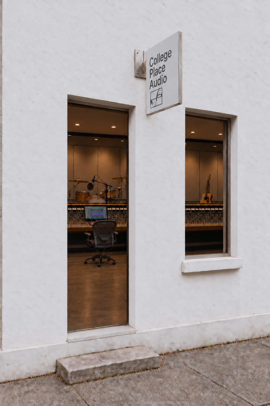 A minimal white studio exterior with a College Place Audio sign